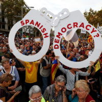 People hold a giant pair of handcuffs during a demonstration organised by Catalan pro-independence movements ANC (Catalan National Assembly) and Omnium Cutural, following the imprisonment of their two leaders, in
